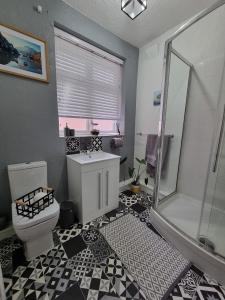 a bathroom with a toilet and a shower and a sink at The View Sandbach in Sandbach