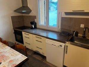 a kitchen with a sink and a counter top at Chalet 6 personnes Gentiane in Les Orres