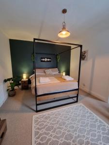 a bedroom with a bed with a black frame at The View Sandbach in Sandbach