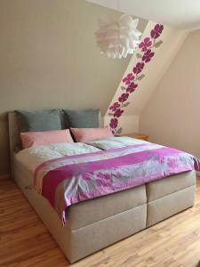 索爾陶的住宿－Ferienwohnung Paulita，一间卧室配有一张带粉色和紫色床单的床