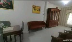 a living room with a couch and a table and chair at D5 Homestay Syariah Sumampir Purwokerto in Purwokerto