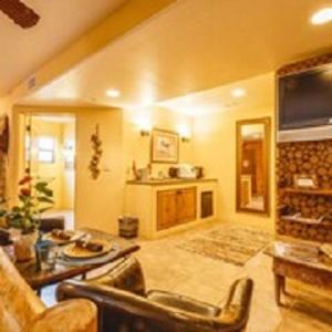 a large living room with a couch and a fireplace at The Inn at Thunder Mountain in Sedona