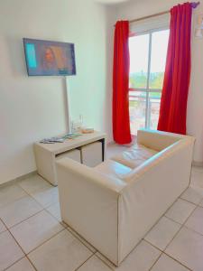 a living room with a couch and a table and a television at ALTOS DE CLERMONT in Cordoba