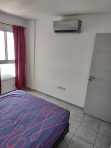 a bedroom with a bed and a window at ALTOS DE CLERMONT in Cordoba