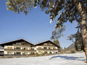 a hotel in the mountains in the snow at Almzeit in Farchant