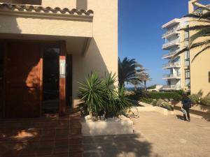 a person standing outside of a house with a building at Camino del Faro LALBIR Alicante in Albir