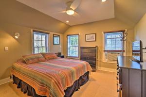 a bedroom with a bed and a dresser and windows at 3-Acre Lodge with Snowmobile and Four-Wheeling Trails in Coudersport
