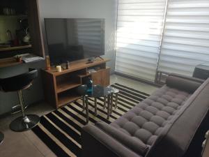 a living room with a couch and a table at Departamento por día 3 dormitorios y 2 baños in Arica
