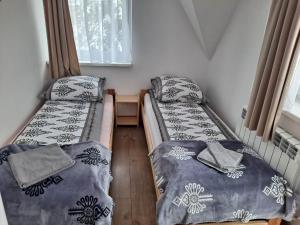 a room with two beds and a window at Willa Ciupaga in Kościelisko