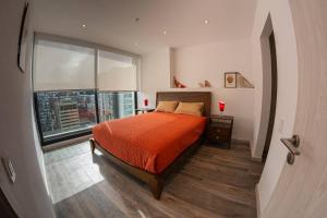 1 dormitorio con cama y ventana grande en Suite Downtown Quito - República del Salvador, en Quito