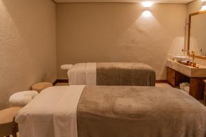 Postel nebo postele na pokoji v ubytování Hotel Boutique & Spa Ponta de Inhambupe by Slaviero Hotéis