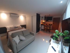 a living room with a couch and a table at Studio 1202 Guarulhos Aeroporto in Guarulhos