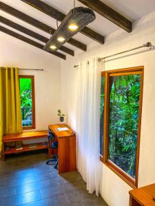 a home office with a desk and a window at Jardines Secretos in Rivas