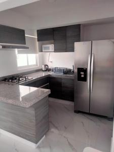 阿卡普爾科的住宿－Acapulco Diamante Banus Residencial，厨房配有不锈钢冰箱和橱柜