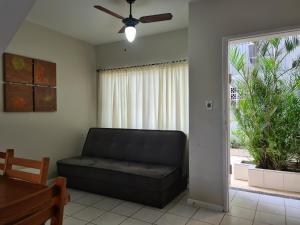 a living room with a couch and a window at Sobrado perto da Praia de Frente para Lagoa - Garopaba in Garopaba