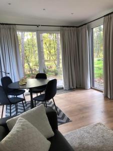 a living room with a couch and a table with chairs at Vakantiewoning Mystiek in Zutendaal