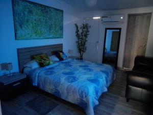 ein Schlafzimmer mit einem Bett mit einer blauen Bettdecke in der Unterkunft APTO 11 CALI - sur in Cali + 2 Fotos