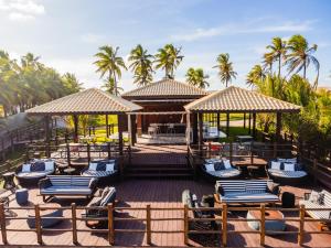 a resort with lounge chairs and umbrellas and palm trees at Ponta de Inhambupe Hotel Boutique & Spa by Slaviero Hoteis in Baixio