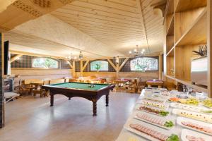 a dining room with a pool table in the middle at Dworek pod Giewontem in Kościelisko