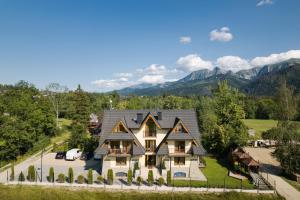 an aerial view of a house with mountains in the background at Dworek pod Giewontem in Kościelisko