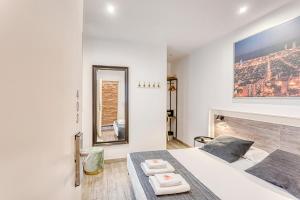 a white bedroom with a bed and a fireplace at HOSTAL BEDMATES in Barcelona