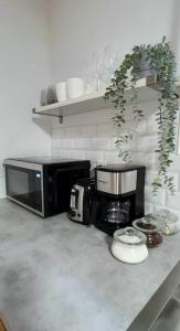 a kitchen counter with a microwave and a coffee maker at Cozy 2-bedroom lower unit! in Barrie