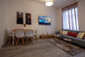a living room with a couch and a table at Central Apartments Vienna in Vienna