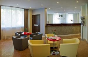 a lobby with a table and chairs and a waiting room at Hotel Komes in Skarżysko-Kamienna