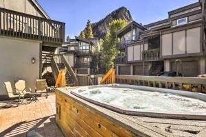 a hot tub in the middle of a courtyard with buildings at Modern Frisco Condo with Deck Walk to Main St! in Frisco