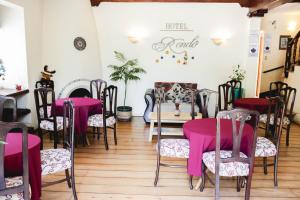 a room with tables and chairs with pink table cloths at Hotel Rondó in Viña del Mar