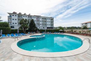 a large swimming pool in front of a hotel at Hotel Troncoso in Sanxenxo