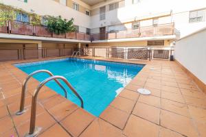 a large swimming pool in the middle of a building at Apartamento La Salle in Seville