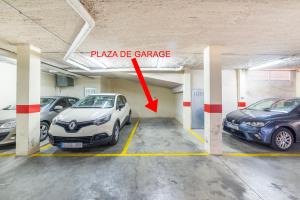a parking garage with two cars parked in it at Apartamento La Salle in Seville
