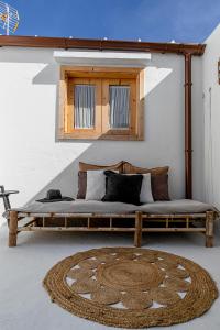 a bed in a room with a window and a rug at LAZURITE MASPALOMAS Apartamentos Sur Gran Canaria in El Tablero