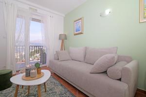 a living room with a couch and a table at Apartment Lana in Dubrovnik