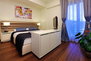 a bedroom with a bed and a television on a cabinet at Hotel Korkyra in Vela Luka +96 photos