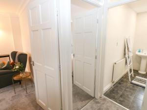 a bathroom with two white closet doors in a room at Maple House in Tadcaster +28 photos