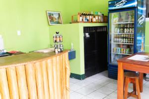a bar in a restaurant with a drink refrigerator at Hotel Villas Lucciana in El Paredón Buena Vista