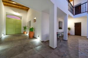 a hallway with a green door and a table at CASA VERDE Comfortable Air-Conditioned Modern Apartments in Ingenio