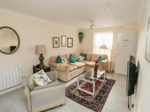 a living room with a couch and a table at The White House in Torquay
