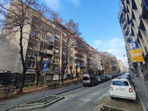 a street with cars parked on the side of the road at Vracar hideaway with private garage in Belgrade