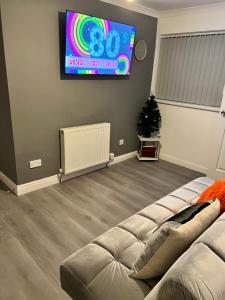 a living room with a couch and a tv at Rhyl beach town apartment in Rhyl