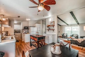 a kitchen and living room with a ceiling fan at Renovated Bungalow Getaway in Philomath