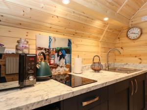 a kitchen counter with a sink and a clock at The Shearer - Crossgate Luxury Glamping in Penrith