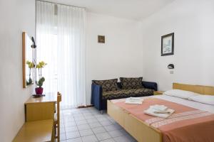 Postel nebo postele na pokoji v ubytování Hotel Lugano