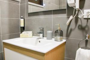 a bathroom with a white sink and a mirror at São Pedro Country House in Campo Maior