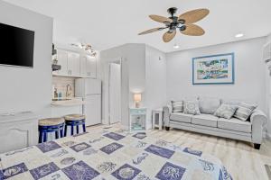 a living room with a bed and a couch at Sea Rocket 21 in St. Pete Beach