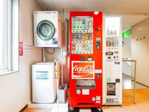 a coca cola vending machine in a room at HOTEL SHAROUM INN - Vacation STAY 04975v in Hakodate