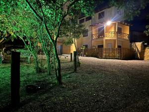 a house with a light on the side of it at night at Studios Aromas do Campeche - Floripa in Florianópolis