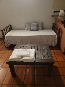 a bench with a bed in a room at Solares de la Bahía in Tigre